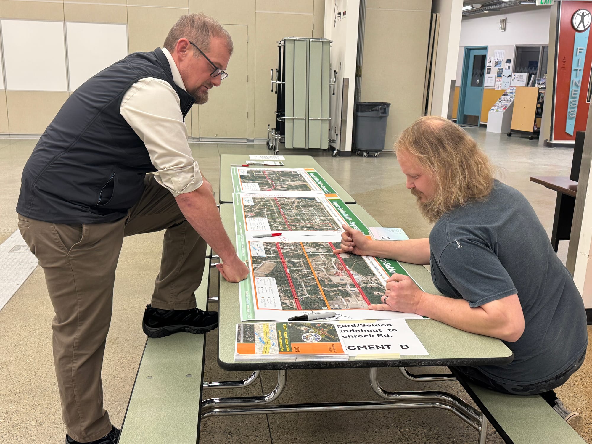 Mat-Su Borough Planning Director Alex Strawn and an area resident discuss a plan