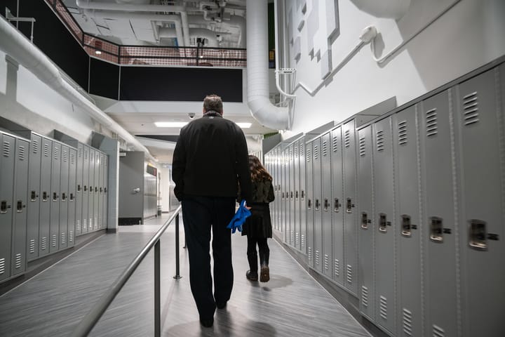 Alaska Governor Mike Dunleavy walks through Gruening Middle School.