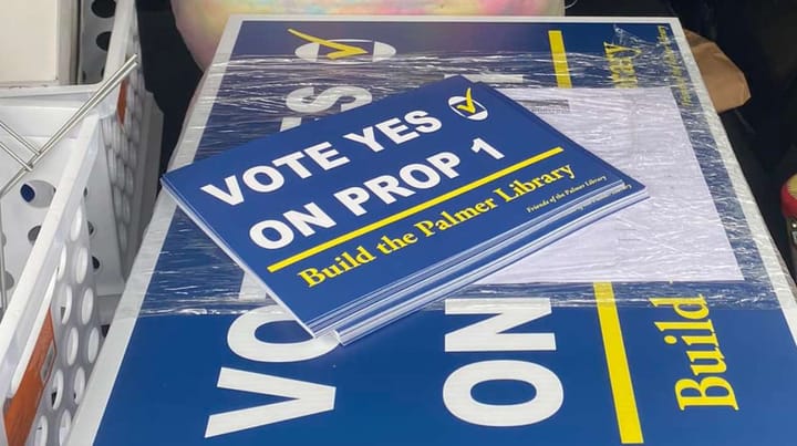 A photo of campaign signs purchased in 2023 by the Friends of the Palmer Public Library.