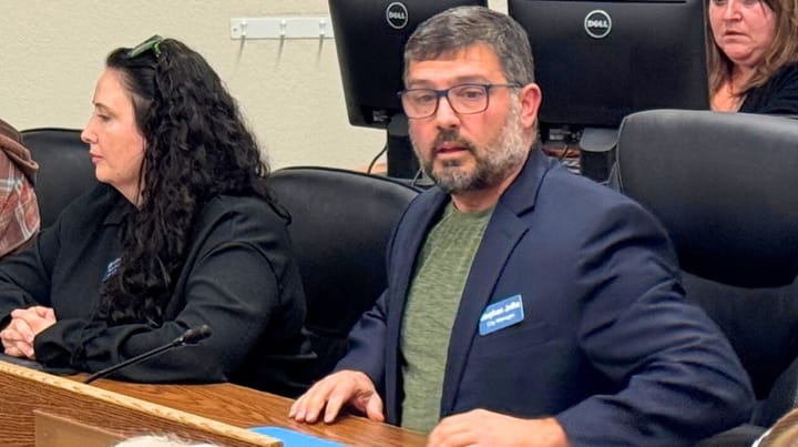 Stephen Jellie sits next to Palmer City Attorny Sarah Heath