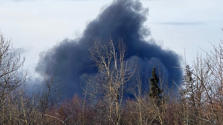 Thick black smoke rises from a large fire on the Mat-Su Central Landfill